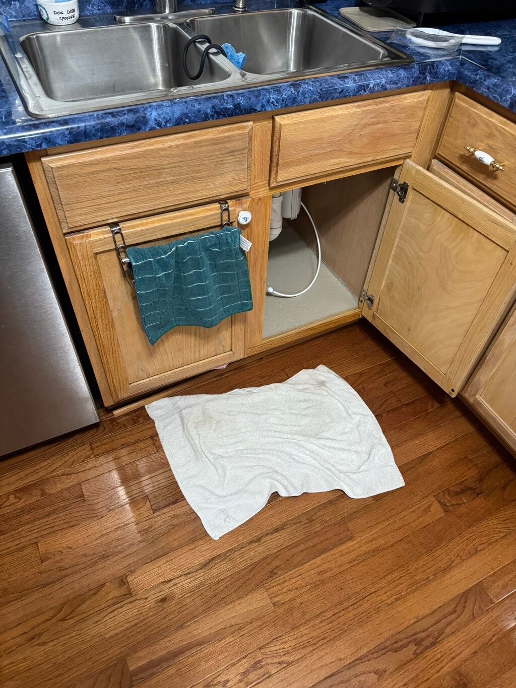 kitchen sink supply line failure with water on hardwood floor, Woodbridge, VA