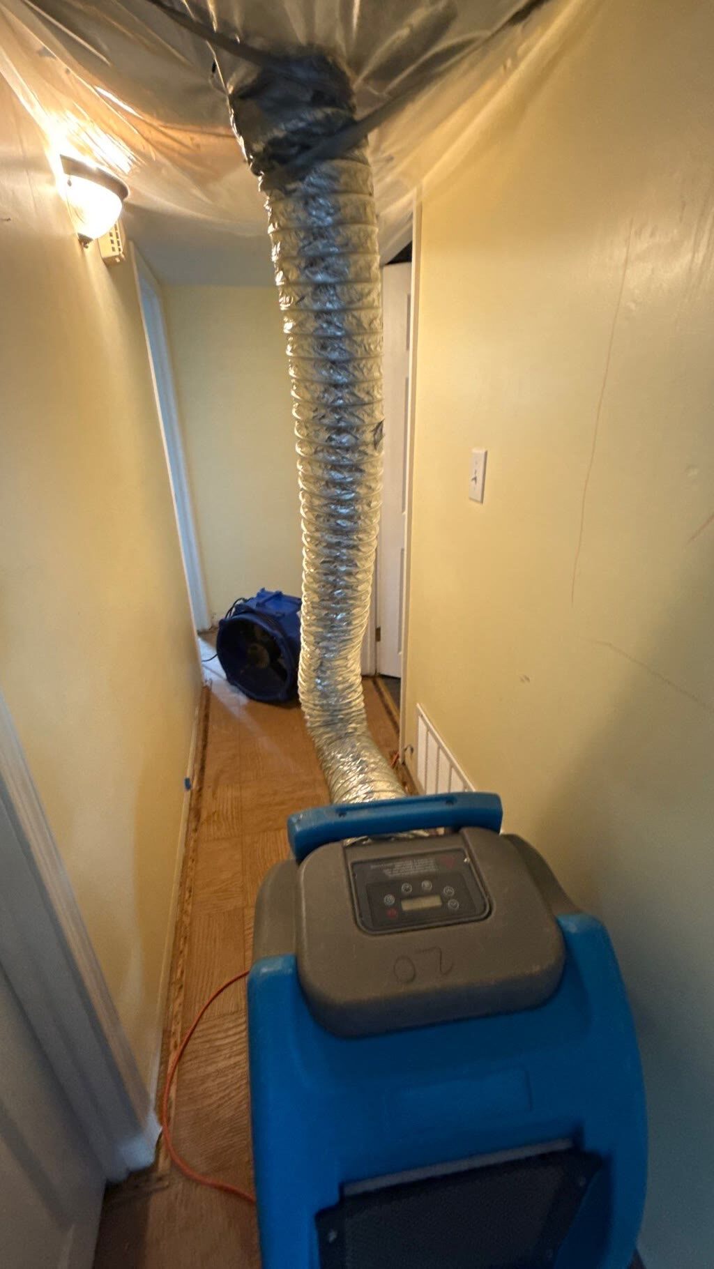 ducted structural drying with dehumidifier and air mover in hallway, Woodbridge, VA