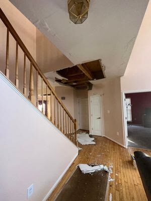 water damage above staircase and hardwood, Manassas VA