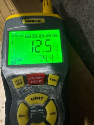 moisture meter showing a 12.5 reading during structural drying verification, Woodbridge VA