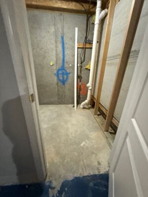 unfinished utility room with exposed stud framing, plumbing lines, and bare concrete floor, Woodbridge VA